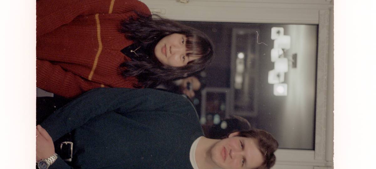Two people standing indoors