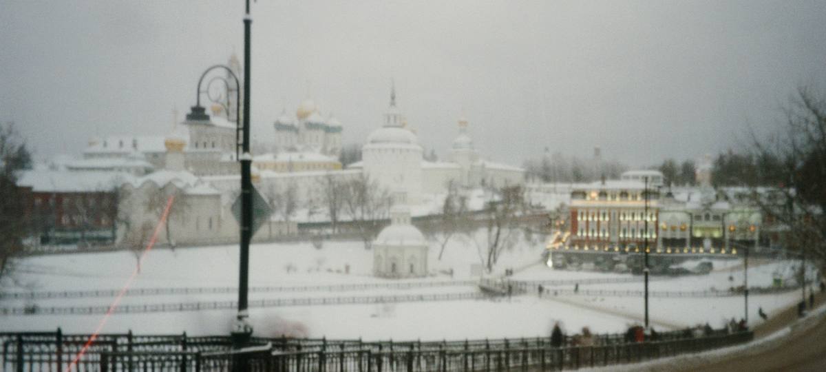Snow-covered city across a river